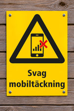 Varningsskylt på trävägg, Svag mobiltäckning